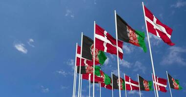 Afghanistan and Denmark Flags Waving Together in the Sky, Seamless Loop in Wind, Space on Left Side for Design or Information, 3D Rendering video