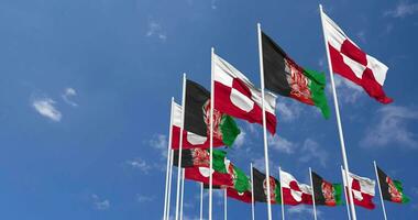 Afghanistan and Greenland Flags Waving Together in the Sky, Seamless Loop in Wind, Space on Left Side for Design or Information, 3D Rendering video