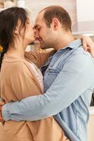 Wife kissing husband nose while dancing in kitchen. Happy young family. Wife and husband love, romance, tender moment, fun and happiness at home, togetherness music cheerful and smile photo