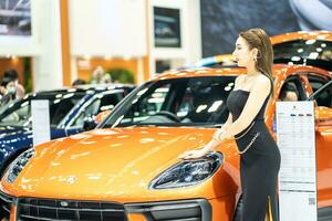 Nonthaburi, Thailand - MAR 26, 2023 Unidentified model poses with a car at The 44th Bangkok international motor show 2023 at IMPACT Arena, Muang Thong Thani, Nonthaburi, Thailand. photo