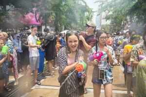 Siam Square, Bangkok, Thailand - APR 13, 2023 Songkran Festival, The short action of people joins celebrations of the Thai New Year or Songkran in Siam Square Bangkok, Thailand. photo