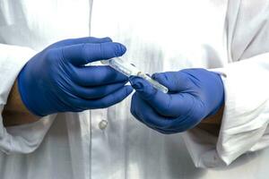 Doctor in blue gloves close up. Hands in blue latex gloves close up. photo