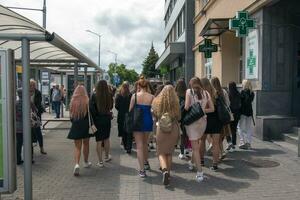 Nitra, Slovakia - 05.19.2023 Beautiful school graduates have fun and rejoice and walk along the city streets. photo