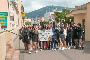 Nitra, Slovakia - 05.19.2023 Beautiful school graduates have fun and rejoice and walk along the city streets. photo