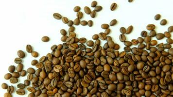 Coffee beans scattered around on a white background video