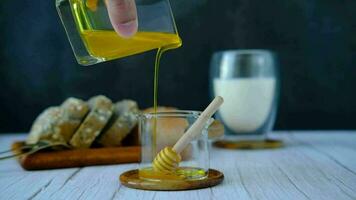 Male hands pouring honey into a measuring glass. video