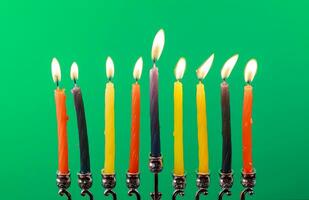 Hanukkah menorah with candles green background isolation photo