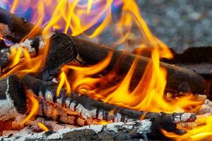 Closeup of flames burning on black background, slow motion. photo