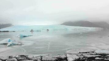 Aerial slow motion rising view Fjallsjokull glacier. The wonderful glacier lagoon of Fjallsarlon in Iceland video