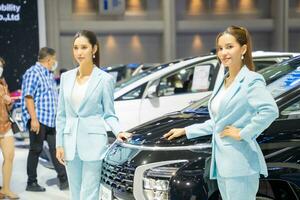 Nonthaburi, Thailand - MAR 26, 2023 Unidentified model poses with a car at The 44th Bangkok international motor show 2023 at IMPACT Arena, Muang Thong Thani, Nonthaburi, Thailand. photo