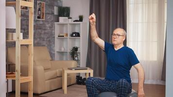 Senior man doing warm up exercise before fitness training. Old person pensioner healthy training healthcare sport at home, exercising fitness activity at elderly age photo