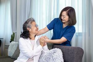 Senior woman get medical service visit from caregiver nurse at home while showing gratitude on appointment for health care and pension welfare insurance concept photo