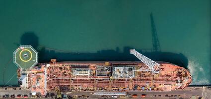 Cargo tanker ship marine vessel docking on oversea berth mooring platform for petroleum and crude oil industry from top view angle photo