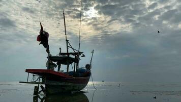 fishing boats during sunset sky at beach landscape, fishing boats during a sunrise or sunset, shimmering of the sun on the clouds,the sky and clouds have the power to inspire feelings of awe or wonder video