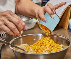 Vibrant swan and corn salad with succulent tomatoes, oil, and onion as the filling photo