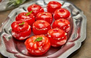 Rustic Kitchen Scene with Stuffed Tomatoes and Mint Leaves on Metal Tray photo