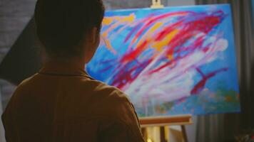 Creative contemporary painter using her imagination on colorful canvas. photo