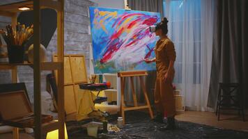 Female painter working on abstract painting in studio. photo