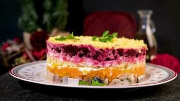 Traditional Russian multi layered salad from herring, beets, potatoes, carrots and eggs. Herring salad under a fur coat. video