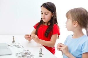 Two kids counting coins together photo