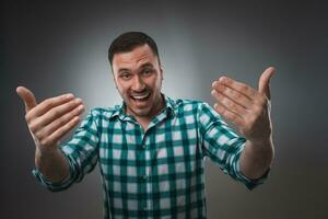 Cheerful man laughing and looking at camera with a big grin. photo