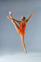 Young slim gymnast in studio photo