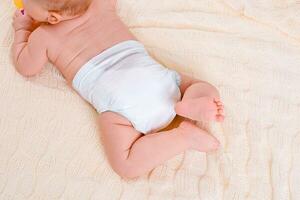 feet of a six months old baby wearing diapers photo