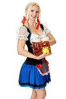 Full length portrait of a blond woman with traditional costume holding beer glasses isolated on white background. photo