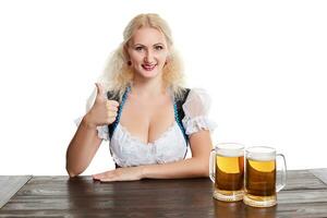 Beautiful young blond girl drinks out of oktoberfest beer stein photo