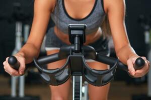 Stationary bicycles fitness girl in a gym sport club. photo