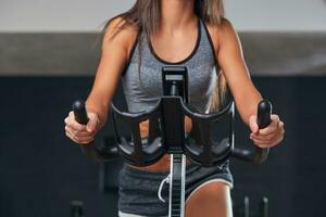 Stationary bicycles fitness girl in a gym sport club. photo