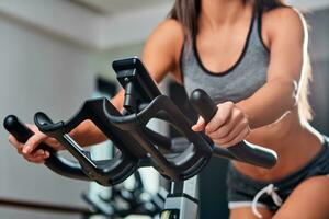 Stationary bicycles fitness girl in a gym sport club. photo