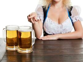 Beautiful young blond girl drinks out of oktoberfest beer stein photo