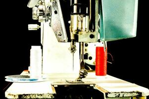 a sewing machine with red thread and a needle photo