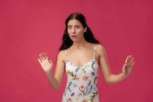 Image of excited screaming young woman on coral background photo