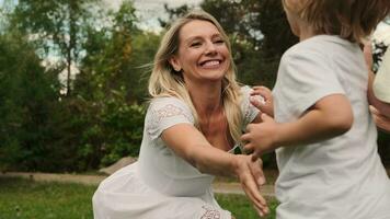 Two sons of different ages run to their mother and hug her. video