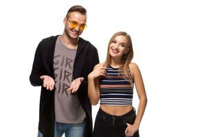 Happy young lovely couple standing together and laughing. Studio shot over white background. photo