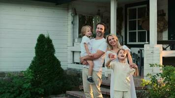 Happy caucasian family are standing near the house. video