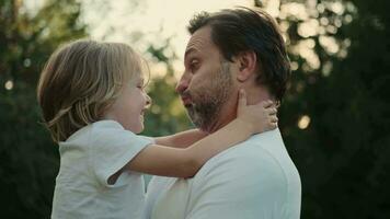 A loving father plays with his son on the lawn near the house. video