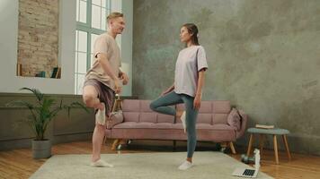 The family is engaged in fitness yoga at home using online technology. video