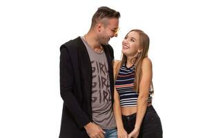 Happy young lovely couple standing together and laughing. Studio shot over white background. photo