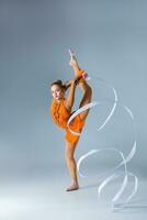 beautiful Caucasian girl gymnast with white ribbon photo