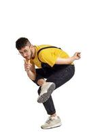 Full-length portrait of a funny guy dancing in studio isolated on white background. photo