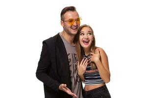 Happy young lovely couple standing together and laughing. Studio shot over white background. photo