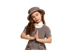 Studio shot of a lovely little kid with a long, curly hair posing isolated on white background. photo