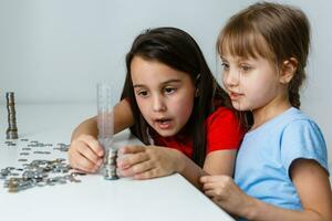 Two kids counting coins together photo