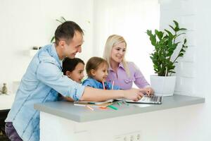 Family Working At Laptop With In Home Office photo