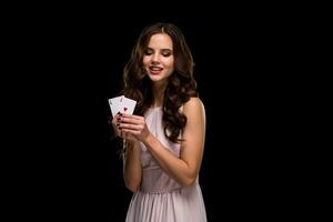 Sexy curly hair brunette posing with chips in her hands, poker concept black background photo