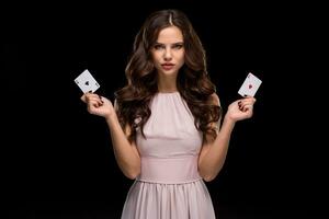 Attractive young woman holding the winning combination of poker cards photo