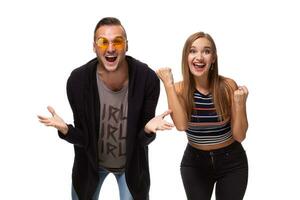 Overjoyed woman and man raise fists with triumph, have successful deal, exclaim joyfully, isolated over white background. photo